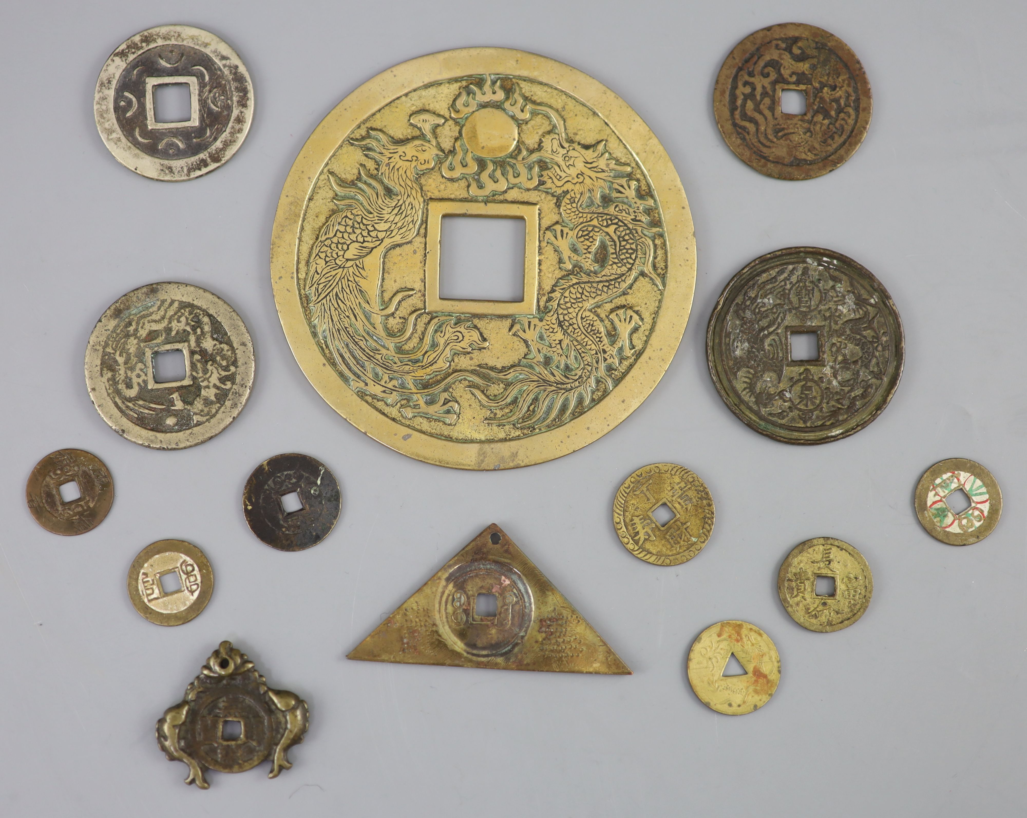 China, a group of 14 bronze and brass coin charms or amulets, Qing to Republic period, F to VF
